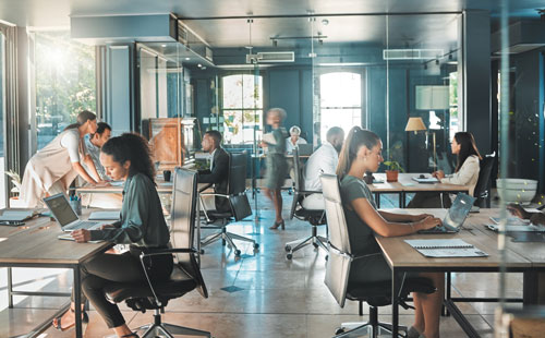 Corporate business using direct primary care for their business with people working in a busy office space.